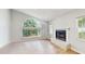 Bright, airy room with a large arched window, a fireplace, and wood flooring at 7845 Clubhouse Estates Dr, Orlando, FL 32819