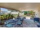 Enclosed patio features cozy seating, a swing and lush landscaping, perfect for outdoor living at 7845 Clubhouse Estates Dr, Orlando, FL 32819