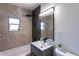 Modern bathroom features a vanity with a black faucet and a shower with a rainfall showerhead at 8 Palm Dr, Ormond Beach, FL 32176