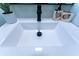 A modern bathroom sink with matte black faucet and fixtures is complemented by tasteful decor at 8 Palm Dr, Ormond Beach, FL 32176