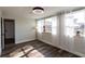 Bedroom with wood-look floors, neutral paint, large windows, sheer curtains and modern lighting at 8 Palm Dr, Ormond Beach, FL 32176