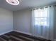 Bedroom with wood-look floors, neutral paint, large window, and sheer curtains at 8 Palm Dr, Ormond Beach, FL 32176