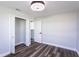 Bright bedroom features wood-look floors, white trim, closet, and ceiling fan with light at 8 Palm Dr, Ormond Beach, FL 32176