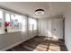 Bedroom with wood-look floors, neutral paint, large windows, and double door closet at 8 Palm Dr, Ormond Beach, FL 32176
