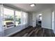 Bedroom with wood-look flooring, neutral paint, large windows, and sheer curtains at 8 Palm Dr, Ormond Beach, FL 32176