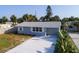 Single-story home with new gray roof, complemented by lush landscaping and a well-maintained yard at 8 Palm Dr, Ormond Beach, FL 32176
