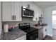 Modern kitchen featuring stainless steel appliances and granite countertops at 8 Palm Dr, Ormond Beach, FL 32176