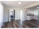 Open concept living room featuring wood-look floors, and an open pass-through to the kitchen and bathroom at 8 Palm Dr, Ormond Beach, FL 32176