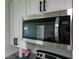 Stainless steel Whirlpool microwave oven above stove and granite countertop at 8 Palm Dr, Ormond Beach, FL 32176