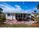 A cozy brick patio is framed by decorative metal posts and offers outdoor seating at 8 Palm Dr, Ormond Beach, FL 32176