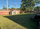 Large backyard with healthy grass, storage shed, and a brick privacy fence at 815 S Solandra Dr, Orlando, FL 32807