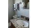 Bathroom featuring granite countertop, white sink, and a window with natural light at 815 S Solandra Dr, Orlando, FL 32807