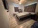 Comfortable bedroom featuring wood-look tile flooring, soft lighting, and large windows at 815 S Solandra Dr, Orlando, FL 32807
