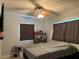 Comfortable bedroom featuring wood-look tile flooring, soft lighting, and large windows at 815 S Solandra Dr, Orlando, FL 32807