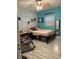 Bright bedroom featuring wood-look tile flooring, soft lighting, and rocking chair at 815 S Solandra Dr, Orlando, FL 32807