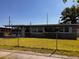 Charming single-story home featuring well-maintained landscaping and a freshly painted exterior with a fenced yard at 815 S Solandra Dr, Orlando, FL 32807