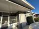 Inviting front porch with screened entry leading to a well maintained home and yard at 815 S Solandra Dr, Orlando, FL 32807
