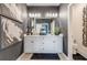 Bathroom featuring a double vanity with white cabinets, modern fixtures, and decorative wall art at 9132 Sw 57Th Ter, Ocala, FL 34476