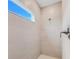 Tiled shower with a chrome shower head and fixtures, accented by a window letting in natural light at 9132 Sw 57Th Ter, Ocala, FL 34476