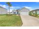 Charming one-story home featuring a well-maintained lawn, light-blue siding, and an attached two-car garage at 9132 Sw 57Th Ter, Ocala, FL 34476