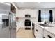Bright kitchen with white cabinets, stainless steel appliances, and a view from the kitchen window at 9132 Sw 57Th Ter, Ocala, FL 34476