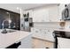 Well-lit kitchen featuring white cabinets, stainless steel appliances, and quartz countertops at 9132 Sw 57Th Ter, Ocala, FL 34476