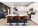 Modern kitchen showcasing white cabinets, stainless steel appliances, and a large island with counter seating at 9132 Sw 57Th Ter, Ocala, FL 34476