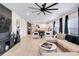 Spacious living room featuring wood-look tile, modern decor, and an open layout to kitchen at 9132 Sw 57Th Ter, Ocala, FL 34476