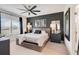 Bedroom with a dark accent wall, ceiling fan, and natural light from the window at 9132 Sw 57Th Ter, Ocala, FL 34476