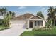 Charming single-Gathering home with a two-car garage, landscaped yard, and inviting front entry at 1019 Morfontaine St, Daytona Beach, FL 32124
