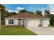 Charming single-story home with a three-car garage, well-manicured lawn, and beautiful landscaping at 1032 Morfontaine St, Daytona Beach, FL 32124