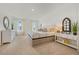 Bright bedroom boasts stylish furnishings, neutral tones, and lots of natural light from two windows at 1035 Morfontaine St, Daytona Beach, FL 32124