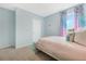 Bright bedroom features a cozy bed, colorful decor, and lots of natural light at 1039 Morfontaine St, Daytona Beach, FL 32124