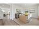 Modern dining room with stylish furniture, decorative wall mirror, and open access to the living area at 1039 Morfontaine St, Daytona Beach, FL 32124