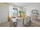 Bright dining area with modern table, large windows, and stylish decor for a welcoming ambiance at 1039 Morfontaine St, Daytona Beach, FL 32124