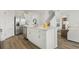 Modern kitchen features stainless steel appliances, white cabinets, and a large island with sink at 1039 Morfontaine St, Daytona Beach, FL 32124
