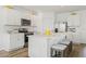 Modern kitchen featuring white cabinetry, stainless steel appliances, and an island with bar seating at 1039 Morfontaine St, Daytona Beach, FL 32124