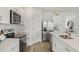 Contemporary kitchen boasts stainless appliances, white cabinets, and stylish countertops for a modern look at 1039 Morfontaine St, Daytona Beach, FL 32124