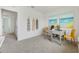 Bright office space with a light gray desk, two yellow chairs, and calming beach themed art at 1039 Morfontaine St, Daytona Beach, FL 32124
