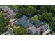Expansive backyard with pool, tennis court, and boat dock on the water and lush landscaping creates a private oasis at 10849 Emerald Chase Dr, Orlando, FL 32836