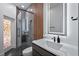 Modern bathroom with a glass walk-in shower, floating vanity, and backlit mirror at 10849 Emerald Chase Dr, Orlando, FL 32836