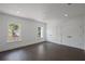 An airy bedroom featuring a dark hardwood floors, two closets and large windows at 10849 Emerald Chase Dr, Orlando, FL 32836