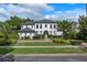 Beautiful two-story home with lush landscaping, mature palm trees, and a welcoming walkway at 10849 Emerald Chase Dr, Orlando, FL 32836