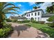 Striking two-story home with lush landscaping, brick driveway and well-manicured lawn offers curb appeal at 10849 Emerald Chase Dr, Orlando, FL 32836