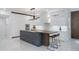 Modern kitchen featuring sleek white cabinets, a large center island, and stainless steel appliances at 10849 Emerald Chase Dr, Orlando, FL 32836