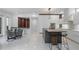 Open-concept kitchen with modern island, sleek cabinetry, and adjacent dining area for easy entertaining at 10849 Emerald Chase Dr, Orlando, FL 32836