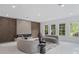 Bright living room featuring a modern fireplace, high ceilings, and plenty of natural light at 10849 Emerald Chase Dr, Orlando, FL 32836