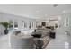 Spacious living area with open floor plan, modern furniture, and access to the pool area at 10849 Emerald Chase Dr, Orlando, FL 32836