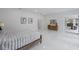Airy main bedroom with wood accents, bright white walls, and a connecting bathroom at 10849 Emerald Chase Dr, Orlando, FL 32836