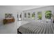 Bright main bedroom with a king-sized bed and large windows overlooking the backyard at 10849 Emerald Chase Dr, Orlando, FL 32836